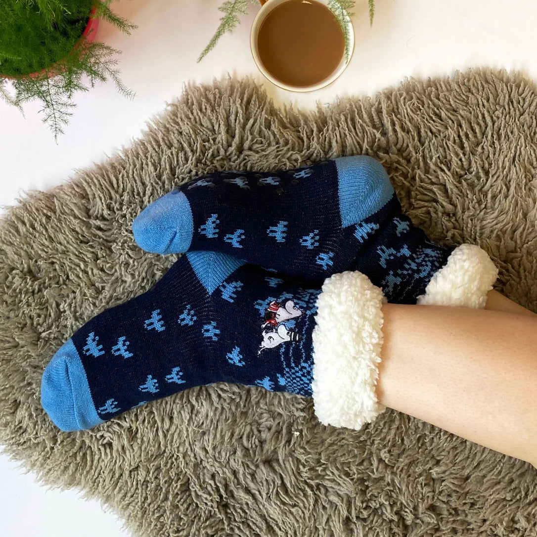 Cosy Moomin character slipper socks on fluffy rug with coffee