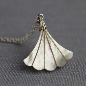 Close-up of Mother of Pearl fan necklace with a silver-plated chain.