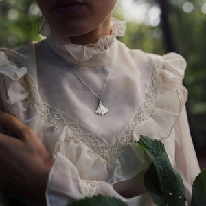 Model wearing the silver-plated Mother of Pearl fan necklace in a vintage-inspired outfit.