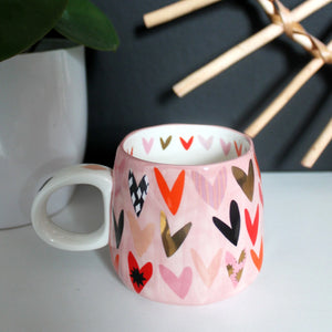 Back of the mug with colourful heart pattern – Rear view of the mug showing all-over vibrant heart design.