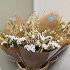 Natural Dried Flower Arrangement featuring an elegant mix of dried grasses and florals in beige and white.