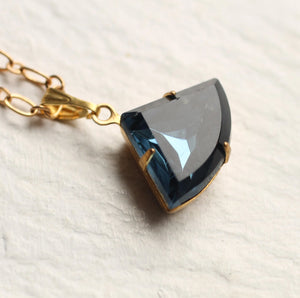 Close-up of the Navy Blue Art Deco Necklace with a faceted vintage glass pendant in a gold-plated setting.