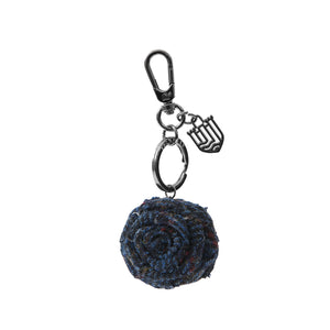 A classic navy over-check Harris Tweed rose keyring, offering a timeless and sophisticated look.