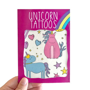 Bright and playful unicorn temporary tattoos by Neon Magpie with pink and blue unicorns, stars, hearts, and rainbows on a colourful backing card.