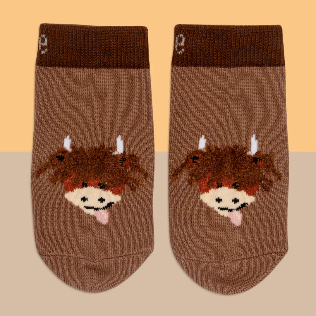 Flat lay of Neutral Highland Cow Socks showing knit texture and fun design