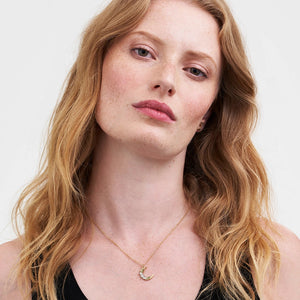 Model wearing Nightshade Moon Gold Chain Necklace with crescent moon floral pendant.