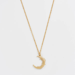 Back view of gold crescent pendant on Nightshade Moon Necklace.