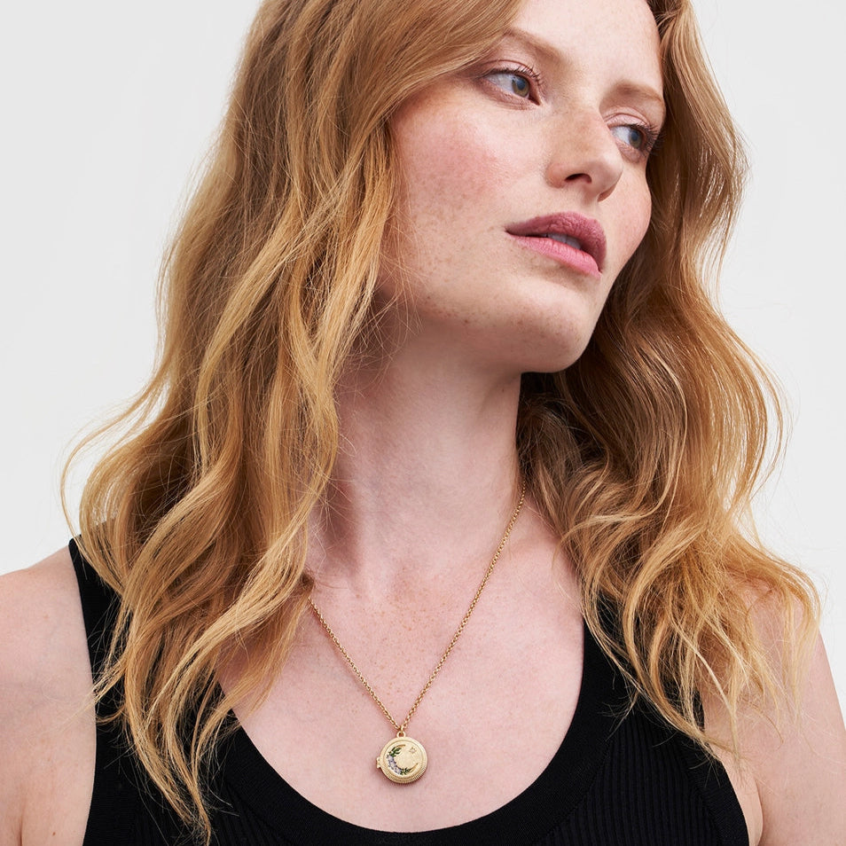 Model wearing Nightshade Moon Round Gold Locket Necklace on a gold chain.