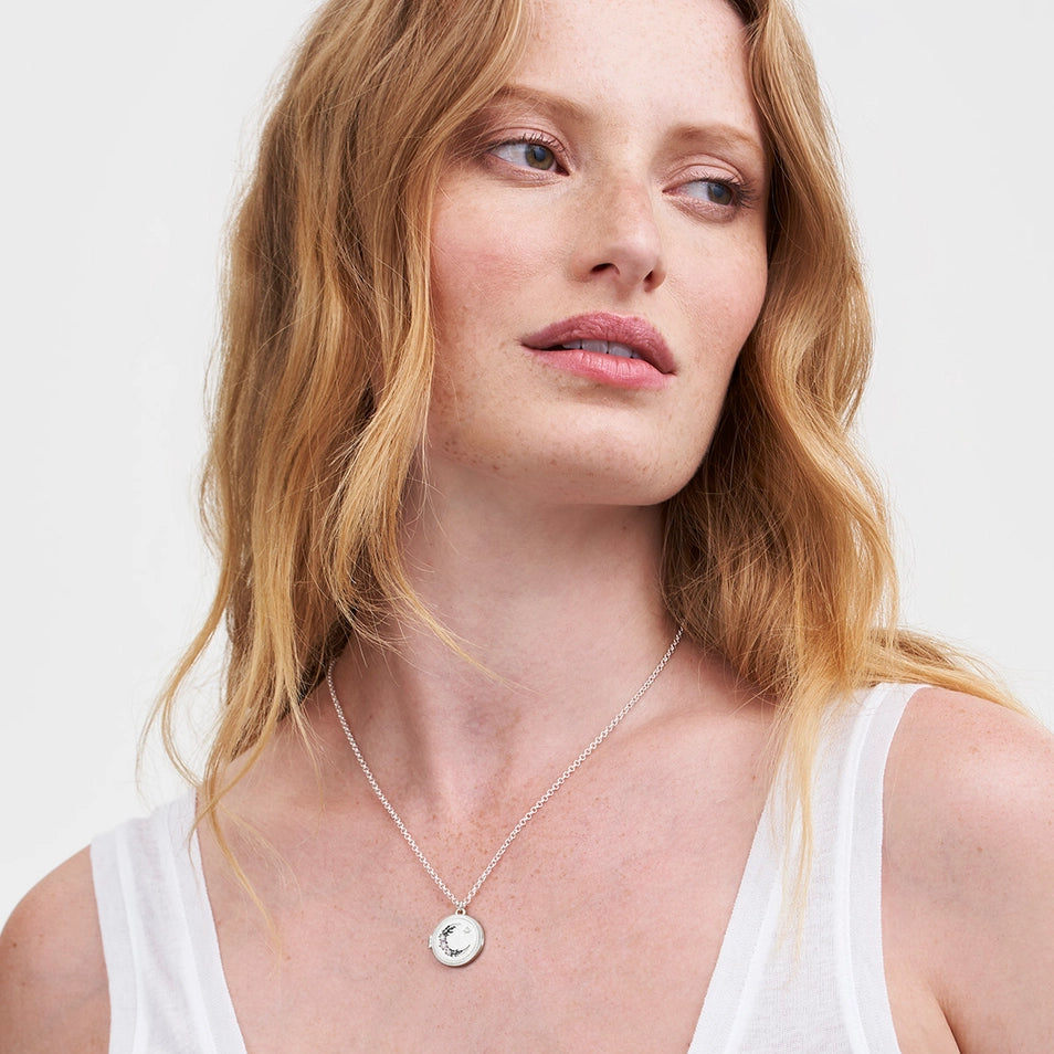 Model wearing Nightshade Moon Silver Locket Necklace on chain.