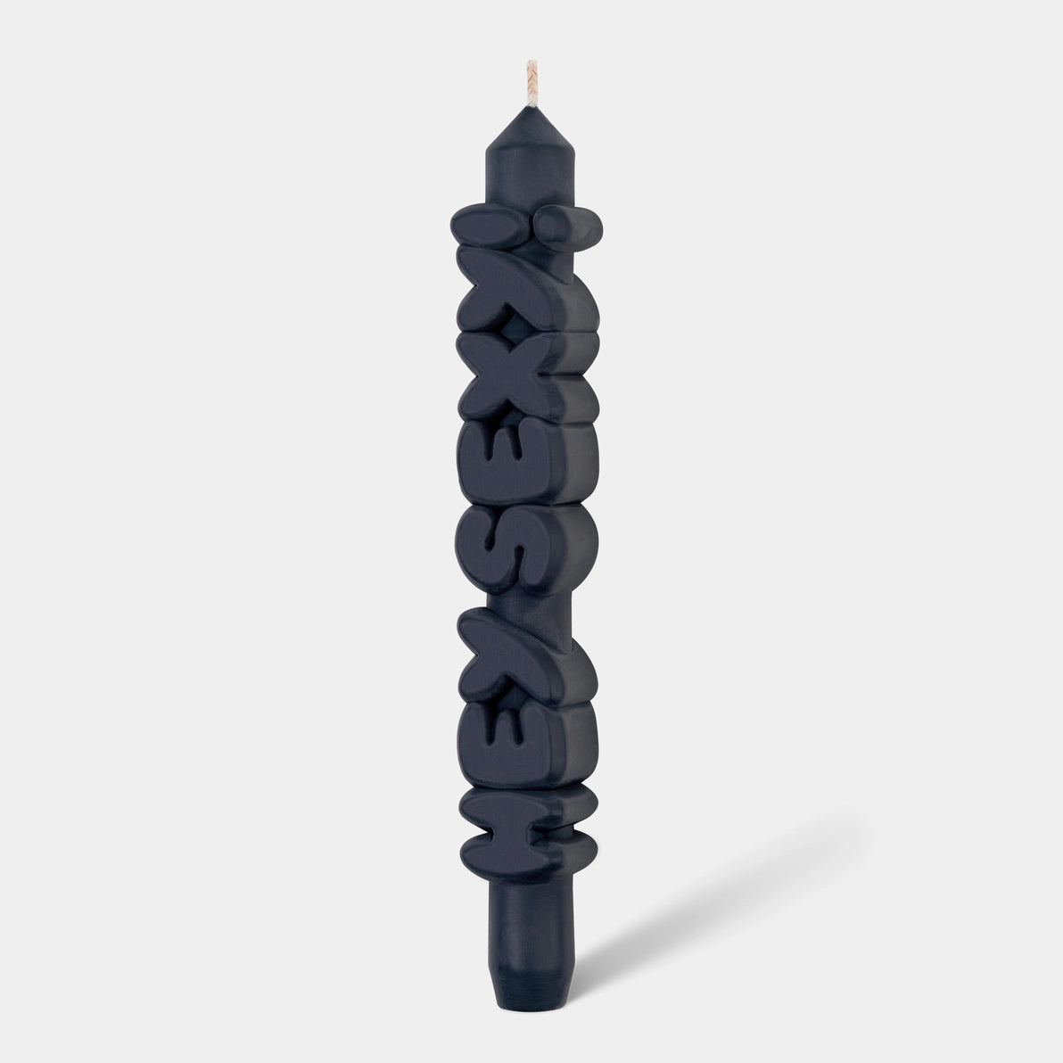 Studio shot of 9-inch black ‘Hey Sexy!’ taper candle with raised lettering, handmade from soy-paraffin wax blend.