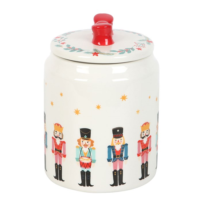 Nutcracker-themed Christmas storage jar with illustrated soldiers and a festive red bow lid, ideal for kitchen Christmas decor and food storage.
