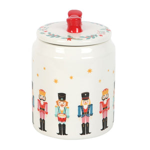 Nutcracker-themed Christmas storage jar with illustrated soldiers and a festive red bow lid, ideal for kitchen Christmas decor and food storage.