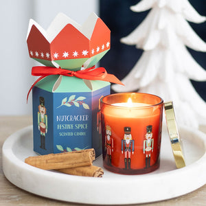 Nutcracker Festive Spice Christmas Candle in red glass jar with gold lid and festive cracker-style gift box.