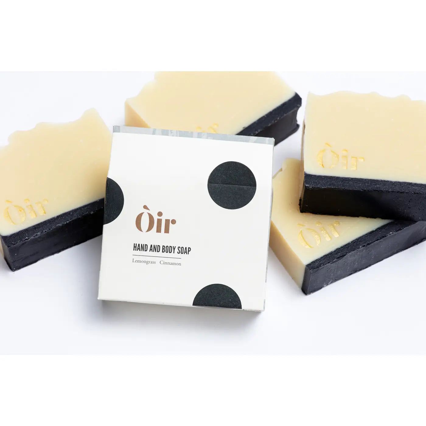 Òir Cinnamon & Lemongrass Soap beside its recyclable cream-and-black dot packaging with scent label.