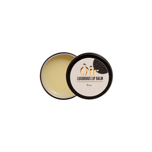 Open tin of Oir Luxurious Lip Balm Rose showing creamy balm and branded lid—natural rose with cocoa & vanilla, 10g.