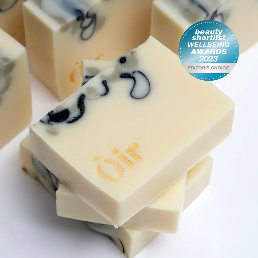 Òir Peppermint Lavender Patchouli Tea Tree Soap bar with gold logo and marbled swirl design.