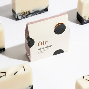 Flat lay of handcrafted Scottish soap bars with swirling charcoal pattern and floral scent.