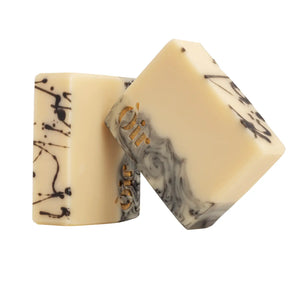 Òir rosemary ho leaf and geranium hand and body soap beside eco-friendly packaging.