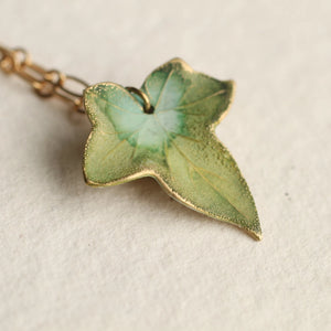 Close-up of Olive Green Ivy Leaf Necklace pendant with intricate hand-painted details.