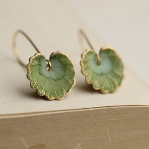 Handmade olive green willow leaf earrings with delicate veining, inspired by Art Nouveau lily pads. Crafted with brass charms and available in matte or glossy finishes.