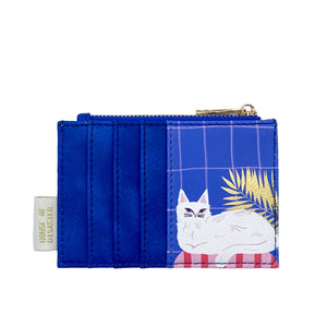 Back view of purse with multiple blue card slots and lounging white cat.