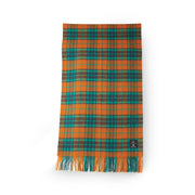 Orange and blue tartan lambswool scarf with fringe edges, folded neatly to show soft woven texture and vibrant check pattern.
