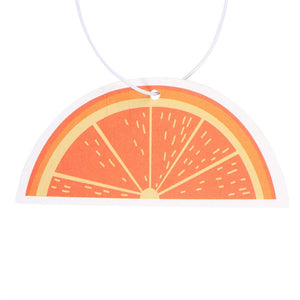 Close-up of orange-slice air freshener with bright citrus print and semi-circle shape – sweet and zesty design.
