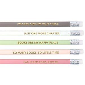 Close-up of gold-foil book quote pencils reading “I’m here for the plot twist” and more.
