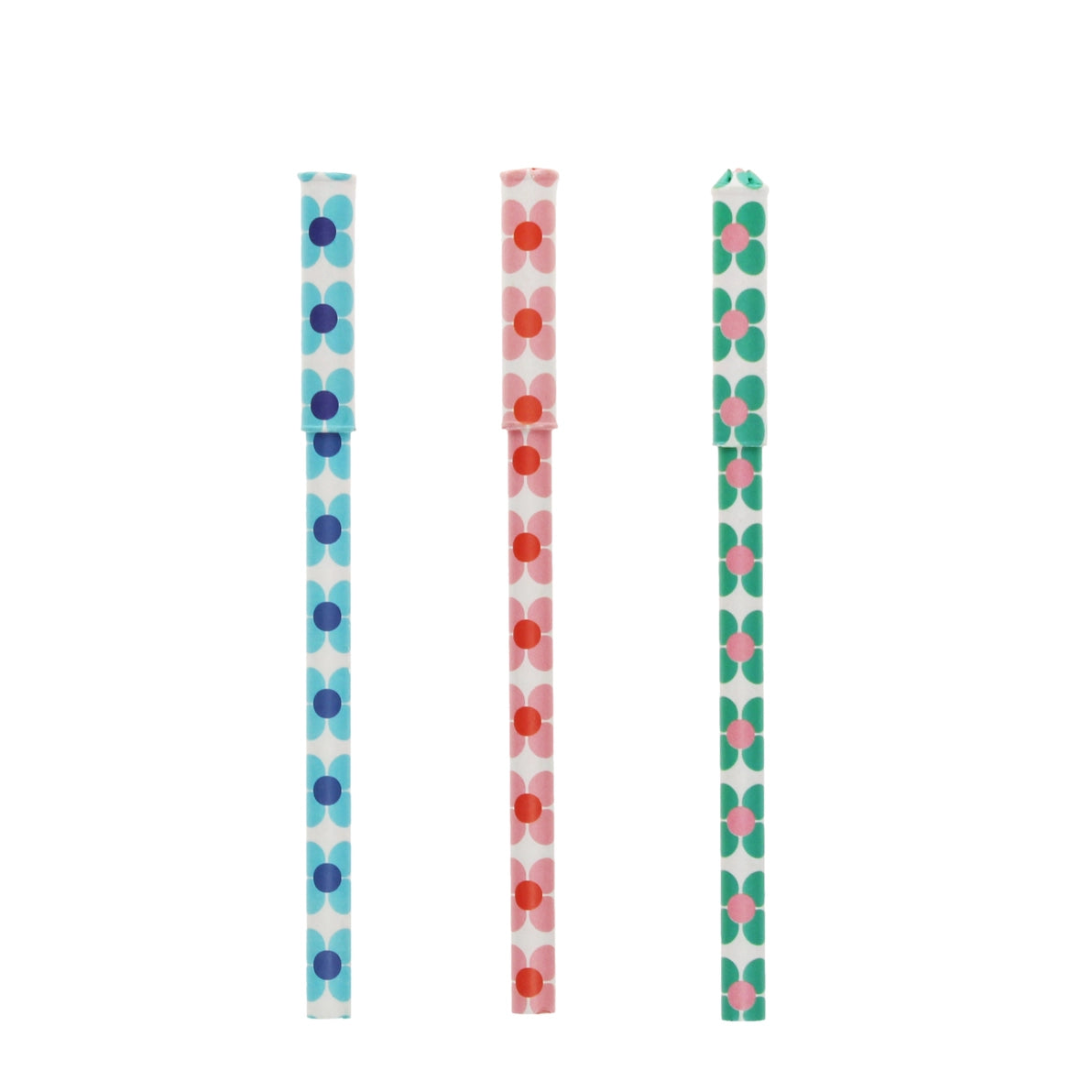 Three daisy patterned paper pens in pink, blue, and green laid out with caps on, showcasing vibrant floral designs.
