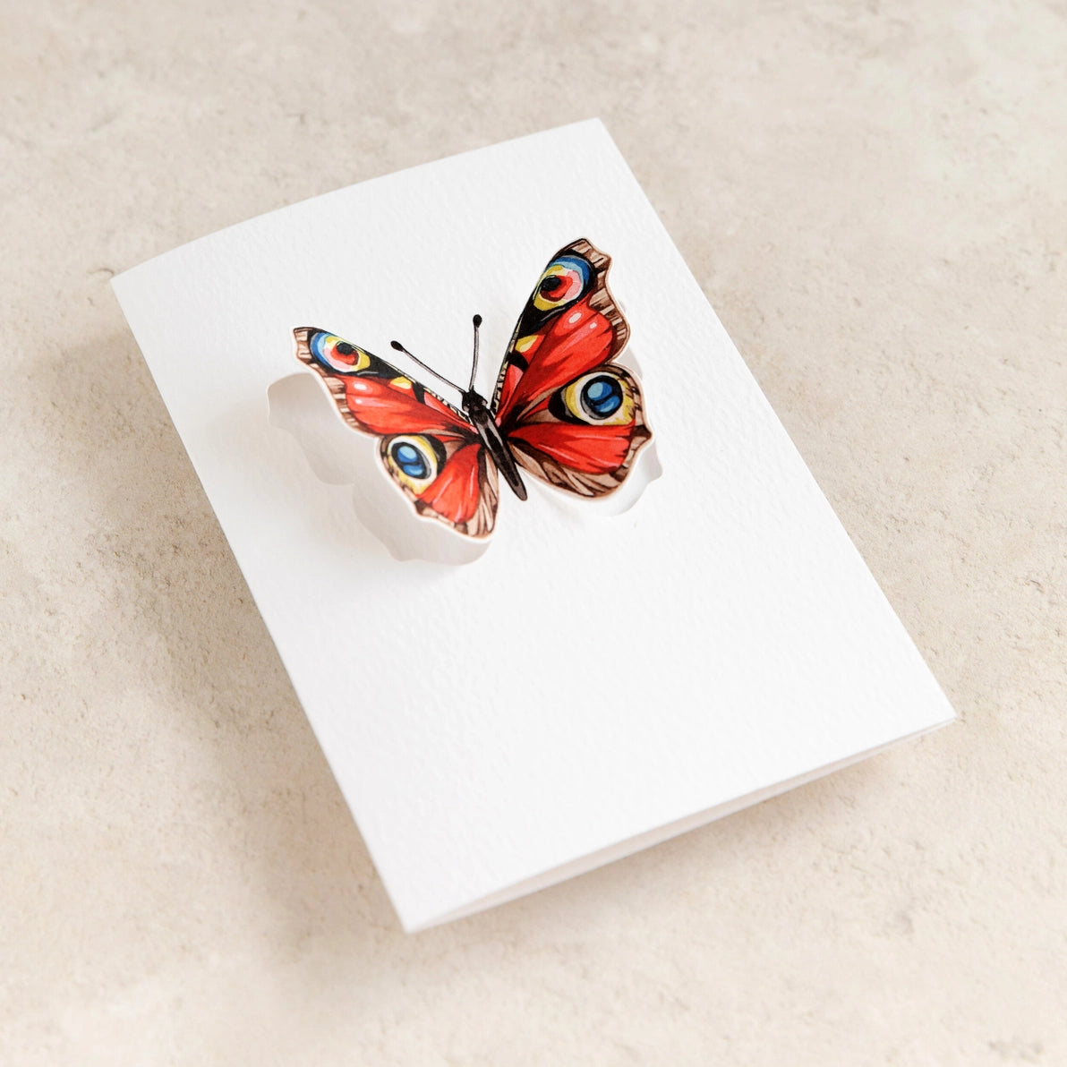 Angled close-up of the 3D pop-out butterfly greeting card.