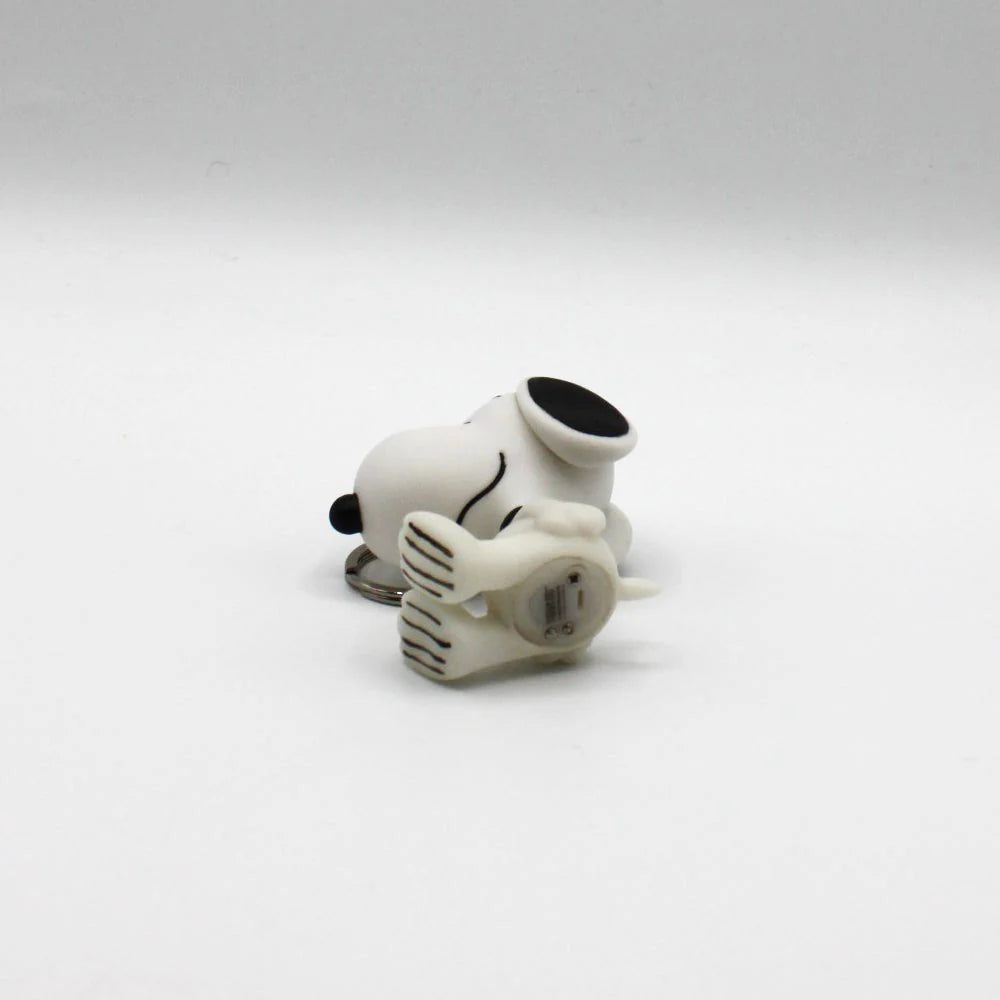 Bottom view of the Snoopy keyring showing the battery compartment and on/off button.