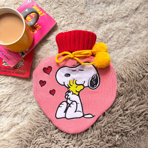 Peanuts Snoopy Love Hot Water Bottle with pink knit cover and applique of Snoopy hugging Woodstock with hearts.