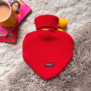 Back view of Peanuts Snoopy Love Hot Water Bottle in red knit with Peanuts label.