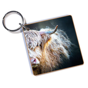 Peekaboo Highland Cow Keyring featuring a close-up digital artwork of a fluffy Highland cow, attached to a durable silver split ring.