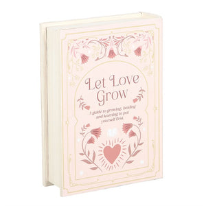Angled view of closed pink book storage box with vintage-style detailing.