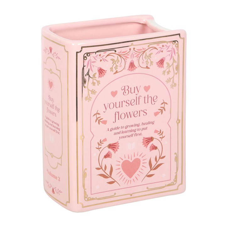 Pink ceramic book shaped vase with floral detailing and heart motif – unique decorative vase for book lovers.