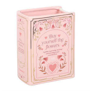 Pink ceramic book shaped vase with floral detailing and heart motif – unique decorative vase for book lovers.