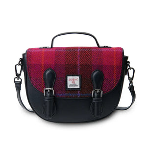 A front view of a red tartan Harris Tweed Cobble Satchel with the shoulder strap draped over the bag.