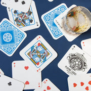 Playing Card Drink Mats scattered with glass of whisky.