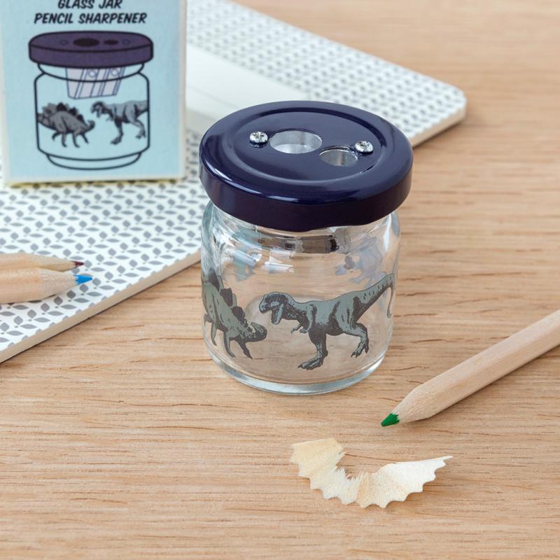 Dinosaur glass jar pencil sharpener on desk with pencils and shavings
