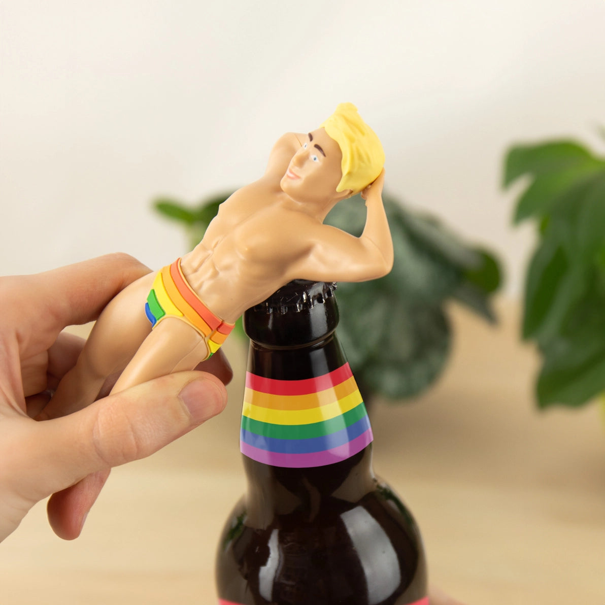 Angled view of the Proud Bottle Opener highlighting its 3D shape, cheeky grin, and playful design, with focus on the metallic texture and sturdy build.