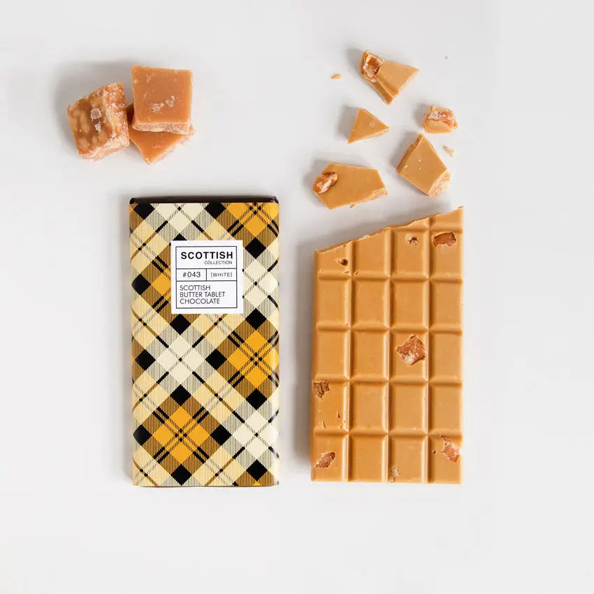 Handmade Scottish Tablet Chocolate Bar with creamy gold and white chocolate, studded with authentic butter tablet pieces and wrapped in a yellow tartan design.