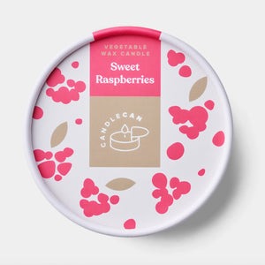 Close-up of the Candlecan Sweet Raspberries candle lid with berry-themed design and bold pink label on white and beige packaging.
