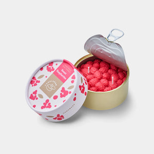 Handmade raspberry-scented candle in realistic berry design, sealed in a pull-tab tin can with illustrated packaging beside it.