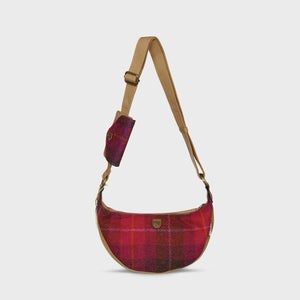 A red tartan Harris Tweed Luna bag with a matching purse attached, on a white background.