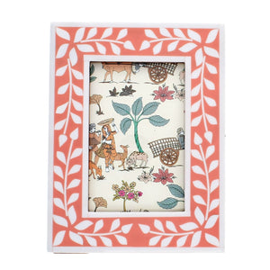 Front view of pink and white leaf-patterned resin photo frame with glass insert.