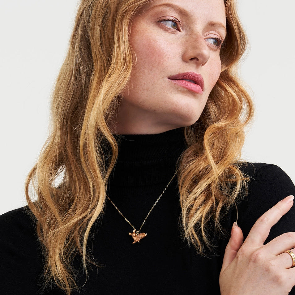 Model wearing Resting Fawn Gold Necklace with black turtleneck.