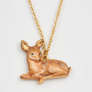 Hand-painted fawn pendant on gold chain detailed view.