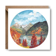 Rocky Mountains in Fall greetings card featuring Charis Raine’s illustration of autumn trees, a mountain lake, and snowy peaks, 15x15cm square card.