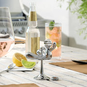 Umbra Rodeo Buddy bottle opener chrome on outdoor table with drinks